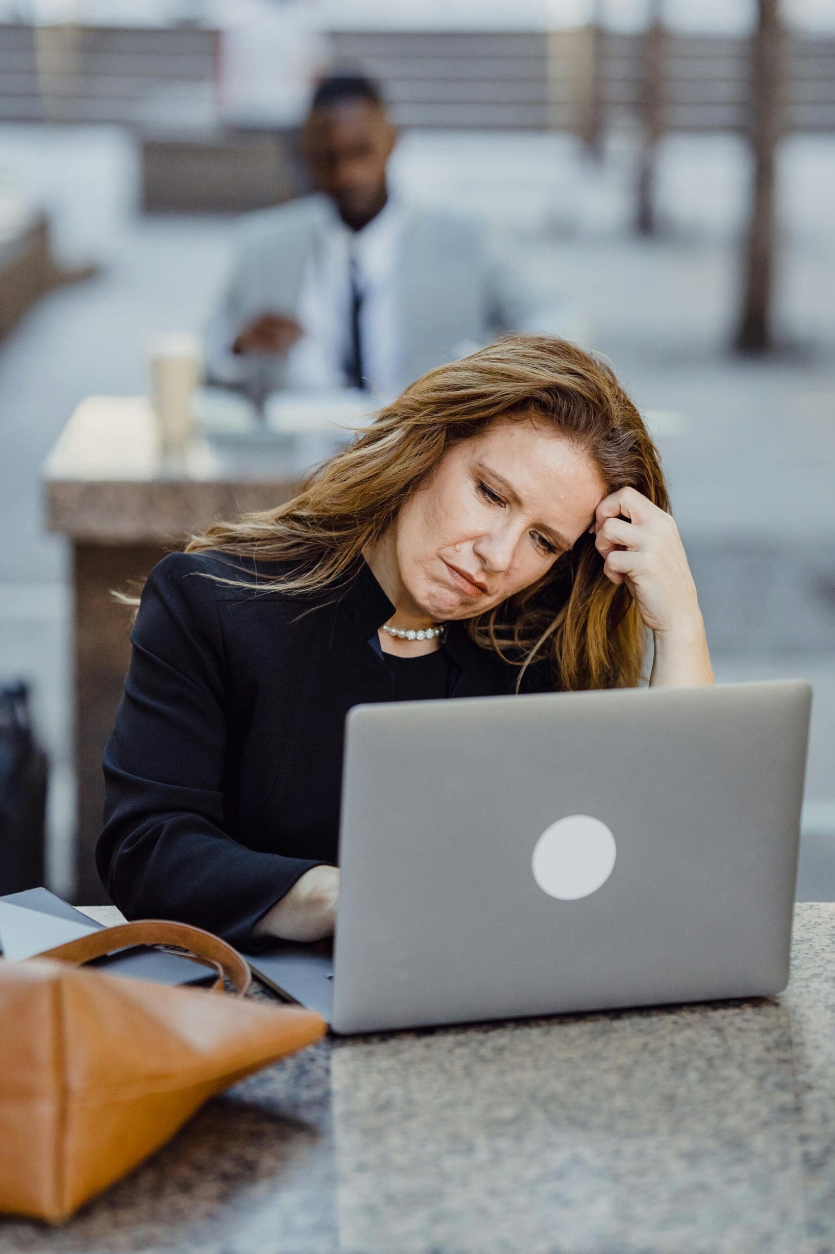 woman in thought at computer